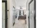 Hallway view into the primary bedroom featuring tray ceilings and an ensuite bath and access to the pool at 13330 Thoroughbred Dr, Dade City, FL 33525