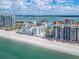 Coastal community with condo buildings, sandy beach, and tranquil waterfront views at 1590 Gulf Blvd # 501, Clearwater Beach, FL 33767