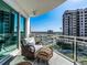 Relaxing balcony view featuring comfortable seating, an elegant glass railing, and beautiful water views at 1590 Gulf Blvd # 501, Clearwater Beach, FL 33767