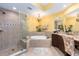 Spacious bathroom featuring a glass shower and soaking tub with chandelier at 1590 Gulf Blvd # 501, Clearwater Beach, FL 33767