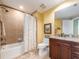 Bathroom features a shower and tub combo, a wood vanity and granite countertop at 1590 Gulf Blvd # 501, Clearwater Beach, FL 33767
