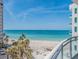 Expansive beach view from the condo balcony, overlooking white sands, turquoise water, and palm trees at 1590 Gulf Blvd # 501, Clearwater Beach, FL 33767