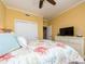 Bright bedroom with a ceiling fan, dresser, and sliding closet doors at 1590 Gulf Blvd # 501, Clearwater Beach, FL 33767