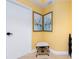 A charming entryway features yellow walls, sailboat art, and a cozy stool, offering a warm welcome at 1590 Gulf Blvd # 501, Clearwater Beach, FL 33767