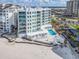 Exterior of condo building on beach, with pool, parking, and waterfront views at 1590 Gulf Blvd # 501, Clearwater Beach, FL 33767