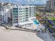 Exterior of condo building on beach, with pool, parking, and waterfront views at 1590 Gulf Blvd # 501, Clearwater Beach, FL 33767
