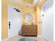 Hallway in condo featuring wood dresser, round mirror, decor, elevator, and tropical-themed decor at 1590 Gulf Blvd # 501, Clearwater Beach, FL 33767