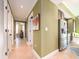 Hallway view to kitchen, showing stainless steel refrigerator and tile flooring at 1590 Gulf Blvd # 501, Clearwater Beach, FL 33767
