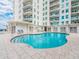 Enjoy this outdoor pool with steps, tile surround, and seating, located at this waterfront building at 1590 Gulf Blvd # 501, Clearwater Beach, FL 33767