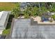 Aerial view of a home with an outdoor patio, greenery and a shingled roof at 1782 Coconut Dr, Venice, FL 34293