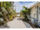 A patio surrounded by tropical plants and a pergola at 1782 Coconut Dr, Venice, FL 34293