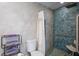 Accessible bathroom features neutral tiling, herringbone shower tile, and a shower seat at 1782 Coconut Dr, Venice, FL 34293