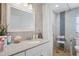 Neutral bathroom with large vanity mirror and an accessible shower with seat at 1782 Coconut Dr, Venice, FL 34293