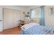 Comfortable bedroom featuring wood floors and a blue floral bedspread at 1782 Coconut Dr, Venice, FL 34293