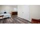 Comfortable bedroom features a light blue bedspread, dark flooring, and a wooden dresser at 1782 Coconut Dr, Venice, FL 34293