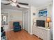 A bedroom with light walls, light wood flooring, and a dresser at 1782 Coconut Dr, Venice, FL 34293