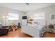 Inviting bedroom with a cozy chair and a bed with bright, natural light from windows at 1782 Coconut Dr, Venice, FL 34293