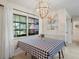 Bright dining area features a checkered tablecloth, modern light fixture, and a window view to the outside at 1782 Coconut Dr, Venice, FL 34293
