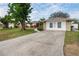 Charming single Gathering home features stone accents, an expansive driveway and a well maintained front lawn with mature shade trees at 1782 Coconut Dr, Venice, FL 34293