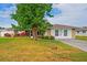 Charming single-story home featuring a lush green lawn, stone accents, and a well-maintained landscape at 1782 Coconut Dr, Venice, FL 34293