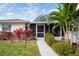 Inviting screened entry porch, complemented by vibrant landscaping, offering a serene welcome at 1782 Coconut Dr, Venice, FL 34293