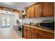 Modern kitchen featuring wood cabinets, updated appliances, and bright lighting for a functional workspace at 1782 Coconut Dr, Venice, FL 34293