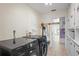 Laundry room with a black washer and dryer and ample cabinet space at 1782 Coconut Dr, Venice, FL 34293