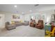 Spacious living room featuring a large sectional sofa, cozy recliners, and stylish decor at 1782 Coconut Dr, Venice, FL 34293