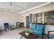 Comfortable screened porch features tile floors, cozy seating, string lights and is surrounded by lush tropical landscaping at 1782 Coconut Dr, Venice, FL 34293