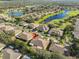 Aerial view of neighborhood showcasing the home's location with surrounding lakes, golf course and mature trees at 1912 Acadia Greens Dr, Sun City Center, FL 33573
