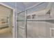 Bathroom featuring a glass-enclosed shower with tiled walls and built-in shelves at 1912 Acadia Greens Dr, Sun City Center, FL 33573