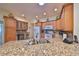 Spacious kitchen features granite countertops, stainless steel appliances, and ample cabinet space at 1912 Acadia Greens Dr, Sun City Center, FL 33573