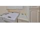 Functional laundry room with modern washer/dryer, utility sink, and built-in storage cabinets at 1912 Acadia Greens Dr, Sun City Center, FL 33573