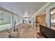 Bright sunroom with tile flooring, dining table, and plenty of natural light from large windows and sliding doors at 1912 Acadia Greens Dr, Sun City Center, FL 33573