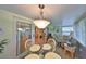 Bright sunroom featuring a dining table, wicker chairs, and a pendant light fixture at 1912 Acadia Greens Dr, Sun City Center, FL 33573