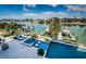 Aerial view of a pool, hot tub, and boat dock overlooking tranquil waters at 199 21St Ave, St Pete Beach, FL 33706