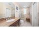 Bathroom featuring a granite vanity, glass-enclosed shower with tile surround, and natural light at 199 21St Ave, St Pete Beach, FL 33706