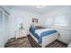 Bright bedroom with a cozy blue bed, white walls, and a large window with blinds at 199 21St Ave, St Pete Beach, FL 33706