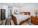 Comfortable bedroom featuring wood floors, a bed with pillows, and a view of the outside at 199 21St Ave, St Pete Beach, FL 33706