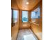 Interior of a residential elevator with tile floors, wood paneling, and a window offering a view of the outside at 199 21St Ave, St Pete Beach, FL 33706