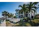 Beautiful waterfront home with outdoor seating areas and lush landscaping, perfect for enjoying coastal living at 199 21St Ave, St Pete Beach, FL 33706