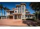Inviting home with tall arched windows, a well-maintained brick driveway, and lush landscaping at 199 21St Ave, St Pete Beach, FL 33706