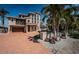 Elegant three-story home featuring a grand entrance, arched windows, and an oversized driveway at 199 21St Ave, St Pete Beach, FL 33706