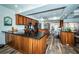 Open kitchen features wood cabinetry, granite countertops, and stainless steel appliances at 199 21St Ave, St Pete Beach, FL 33706