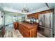 Spacious kitchen boasts stainless steel appliances, wood cabinets, and a central butcher block island at 199 21St Ave, St Pete Beach, FL 33706