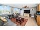 Cozy living room with water views, featuring comfortable seating, a ceiling fan, and built-in kitchenette area at 199 21St Ave, St Pete Beach, FL 33706
