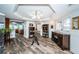 Inviting living room with wood floors, chandelier lighting, and access to the kitchen at 199 21St Ave, St Pete Beach, FL 33706