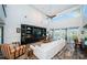Bright and airy living room with vaulted ceilings, a fan, and sliding doors to a private balcony at 199 21St Ave, St Pete Beach, FL 33706