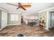 An upstairs loft area with wood flooring, a ceiling fan, and views of the stairwell and surrounding rooms at 199 21St Ave, St Pete Beach, FL 33706