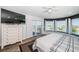 Main bedroom featuring a bay window, balcony access, and wood look floors at 199 21St Ave, St Pete Beach, FL 33706